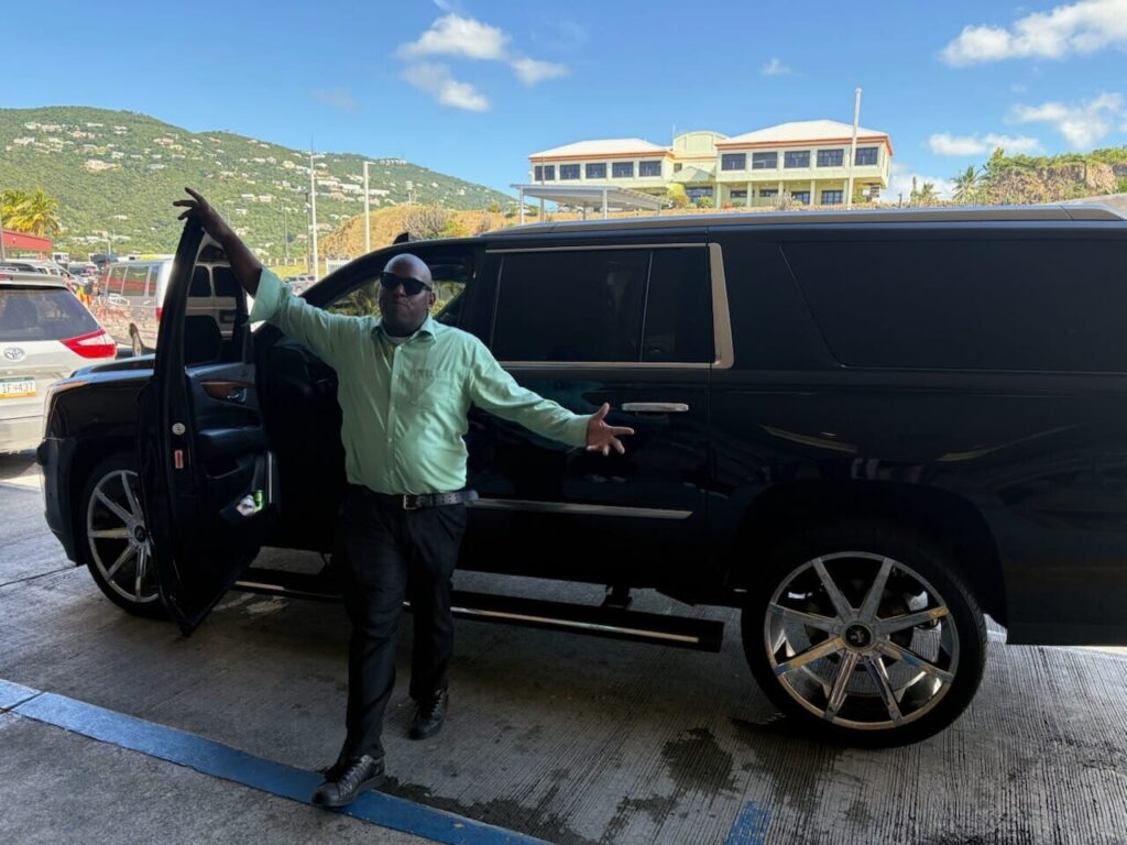 Professional driver standing beside luxury SUV for private airport transfer in St. Thomas USVI Airport Taxi and Transfer Service in St Thomas USVI